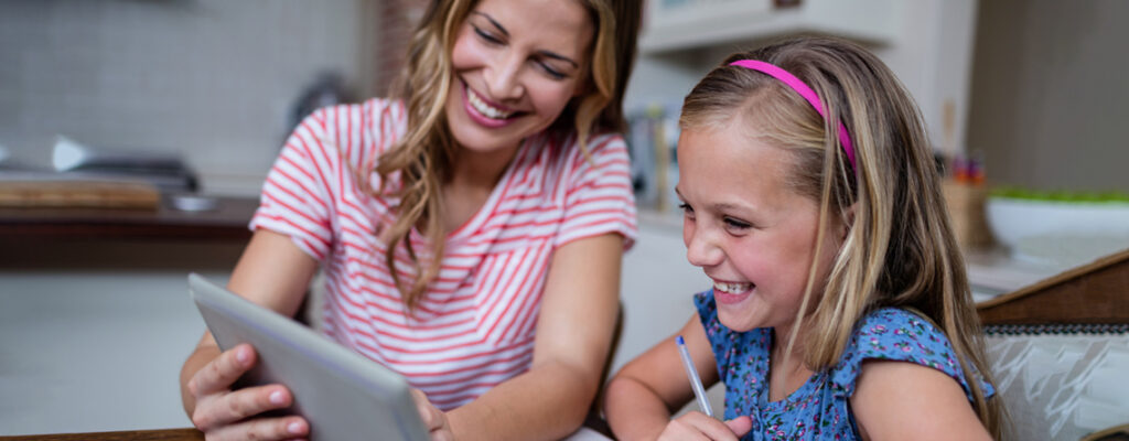 Mother and daughter using tablet for school