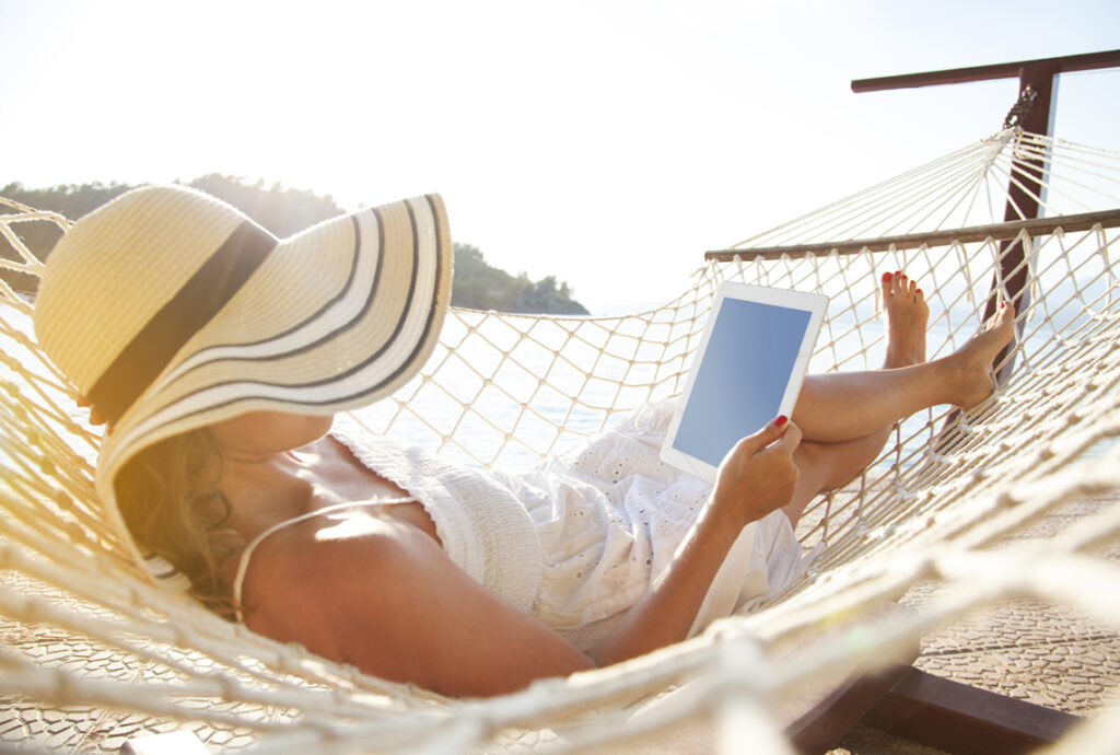 Woman Streaming on Tablet in Hammock