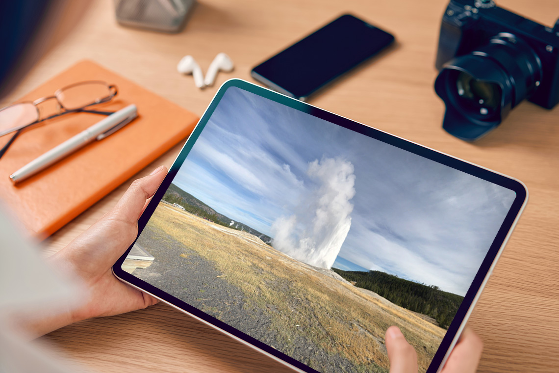 person holding iPad while watching a virtual tour of Yosemite National Park