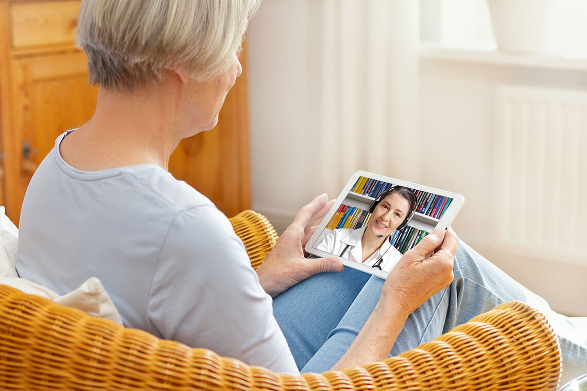 woman speaking with physician on tablet