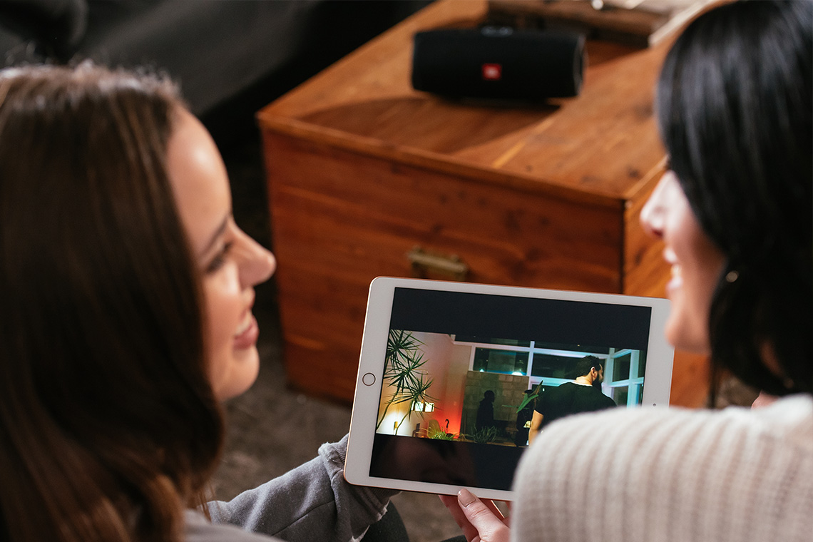 Daughter and mom watching movie together on tablet