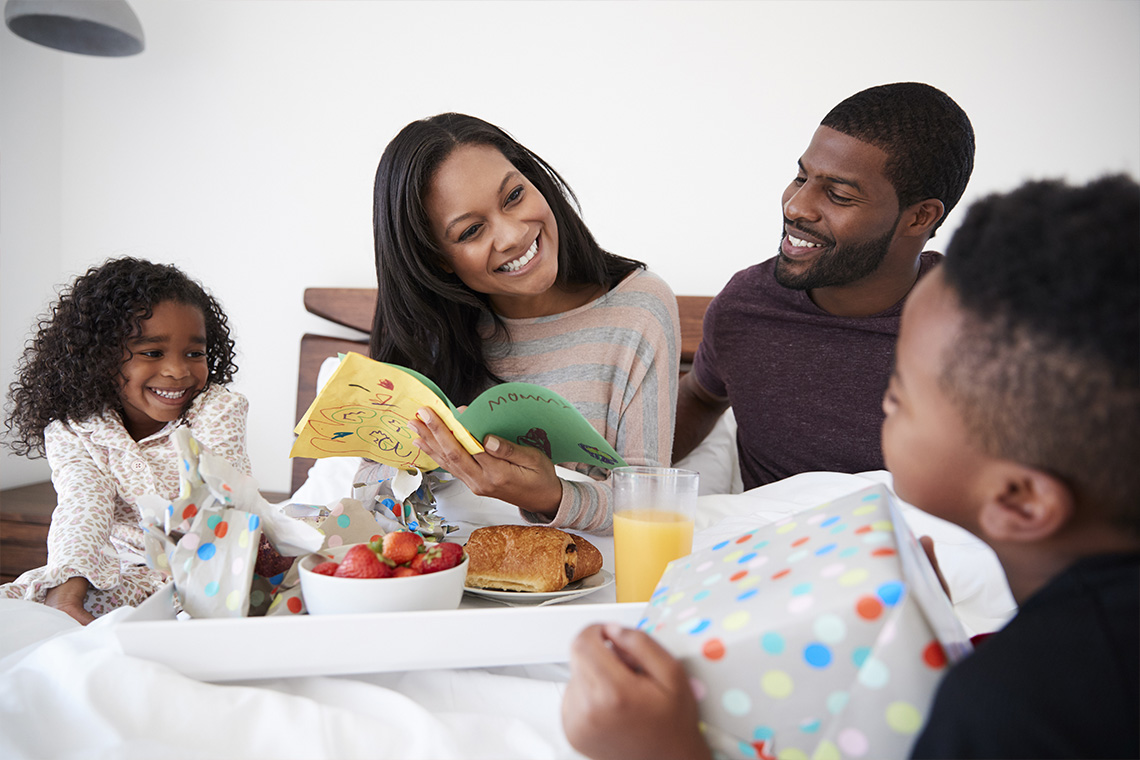mom getting treated to breakfast in bed for Mother's Day