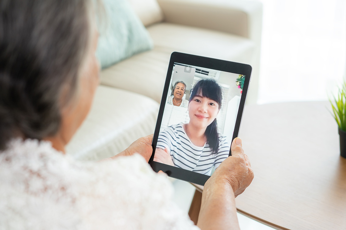 Mom using iPad to see daughter over video call