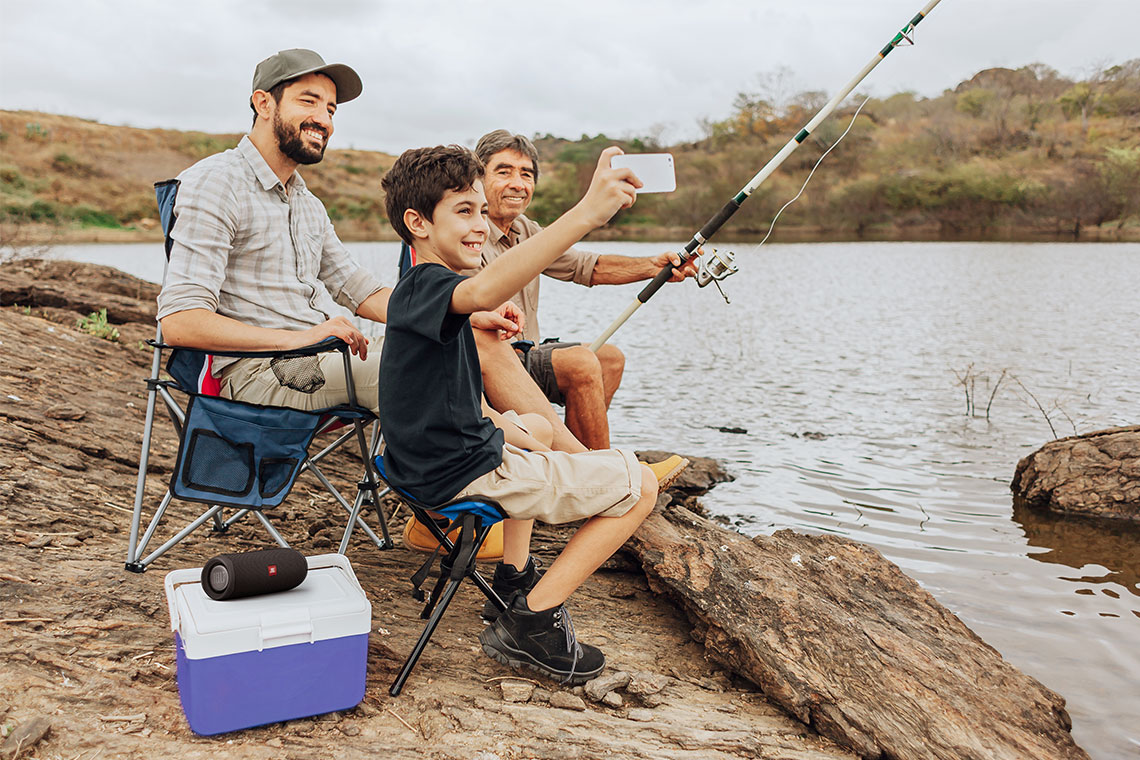 family fishing while listing to music with JBL bluetooth speaker