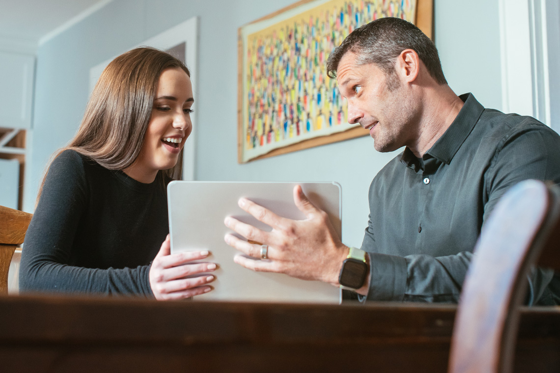 dad helping daughter with homework with Apple iPad