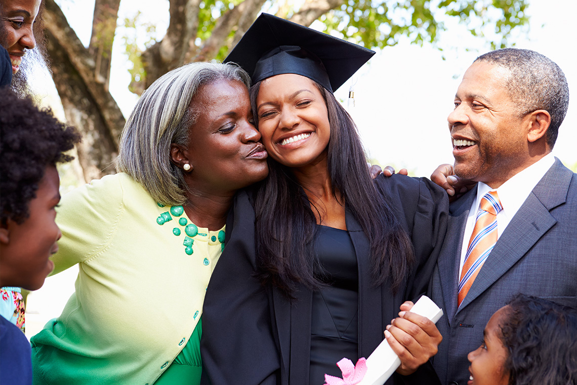 family celebrating graduation with female graduate