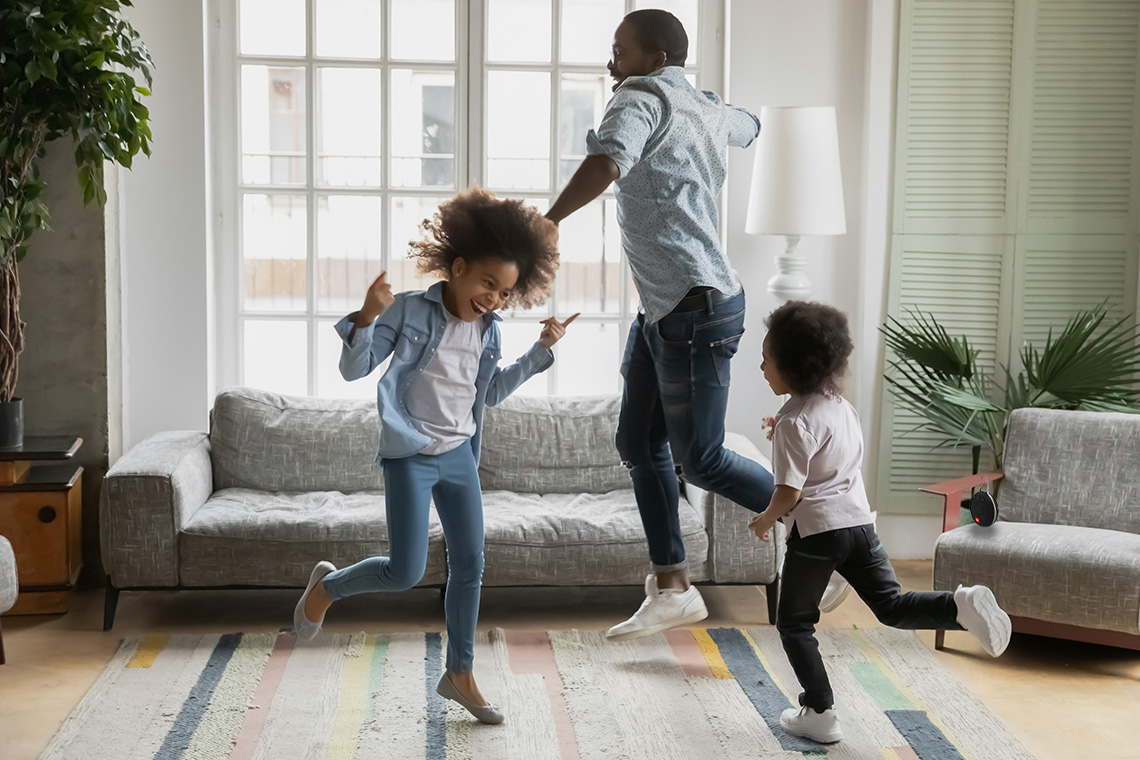 family dancing in living room