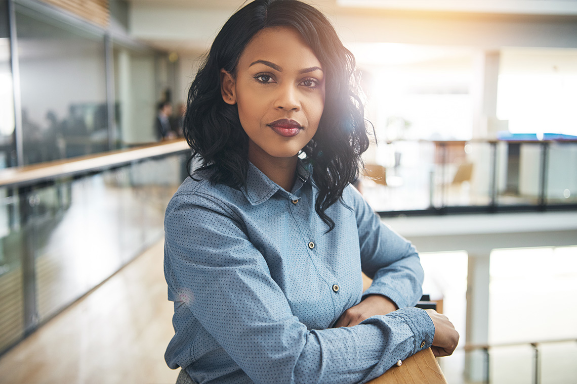 young female graduate with arms folded