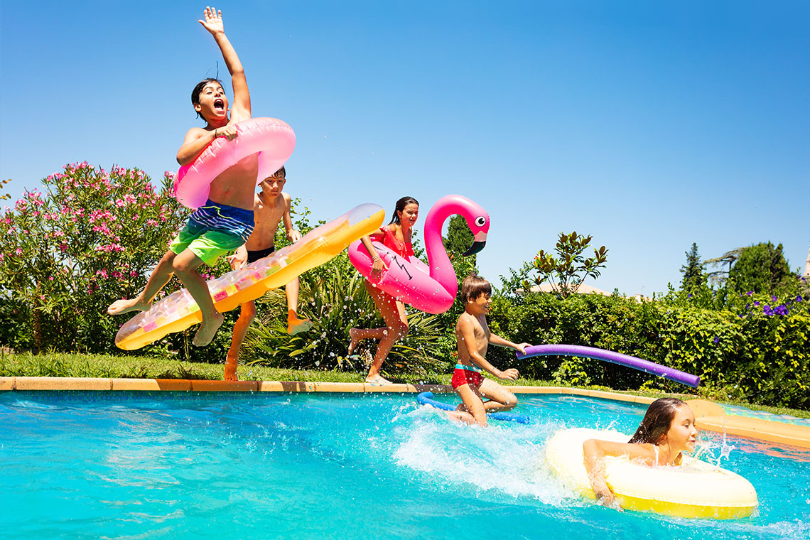 kids jumping in swimming pool - water activities