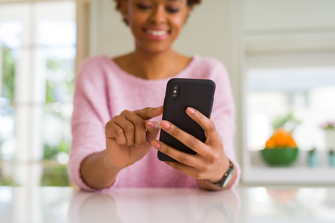 woman using smartphone to check passive income investments