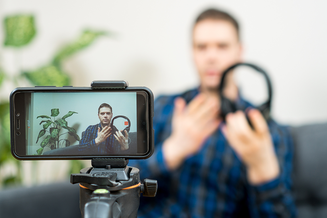 man setting up smartphone to record podcast