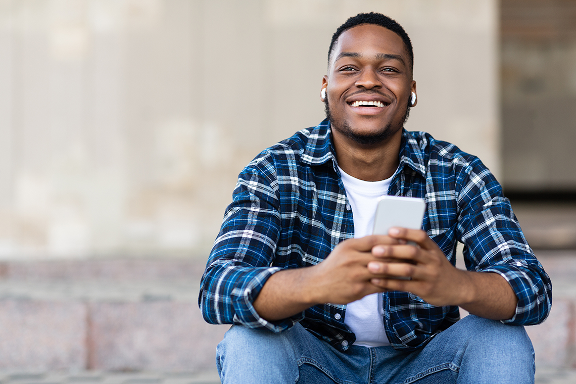 man listening to podcast on smartphone