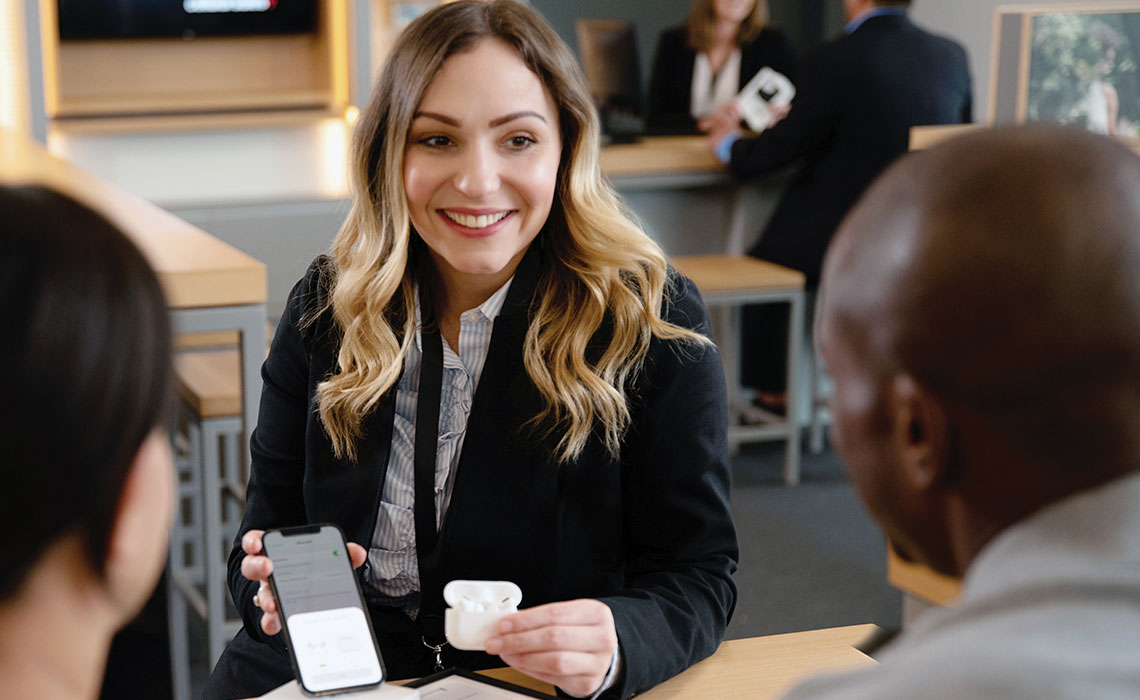 Cellular Sales wireless consultant smiling at excited customer