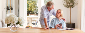 senior couple using smartphone at table