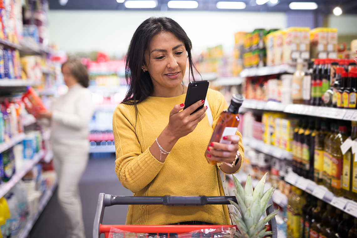 woman scanning barcode of product with app