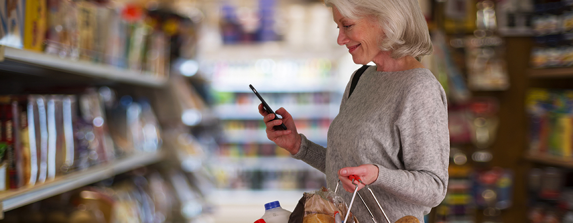 woman using smartphone tools to help with grocery shopping