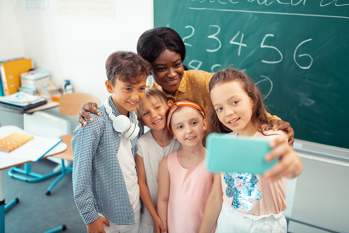 Student taking selfie with classmates and teacher