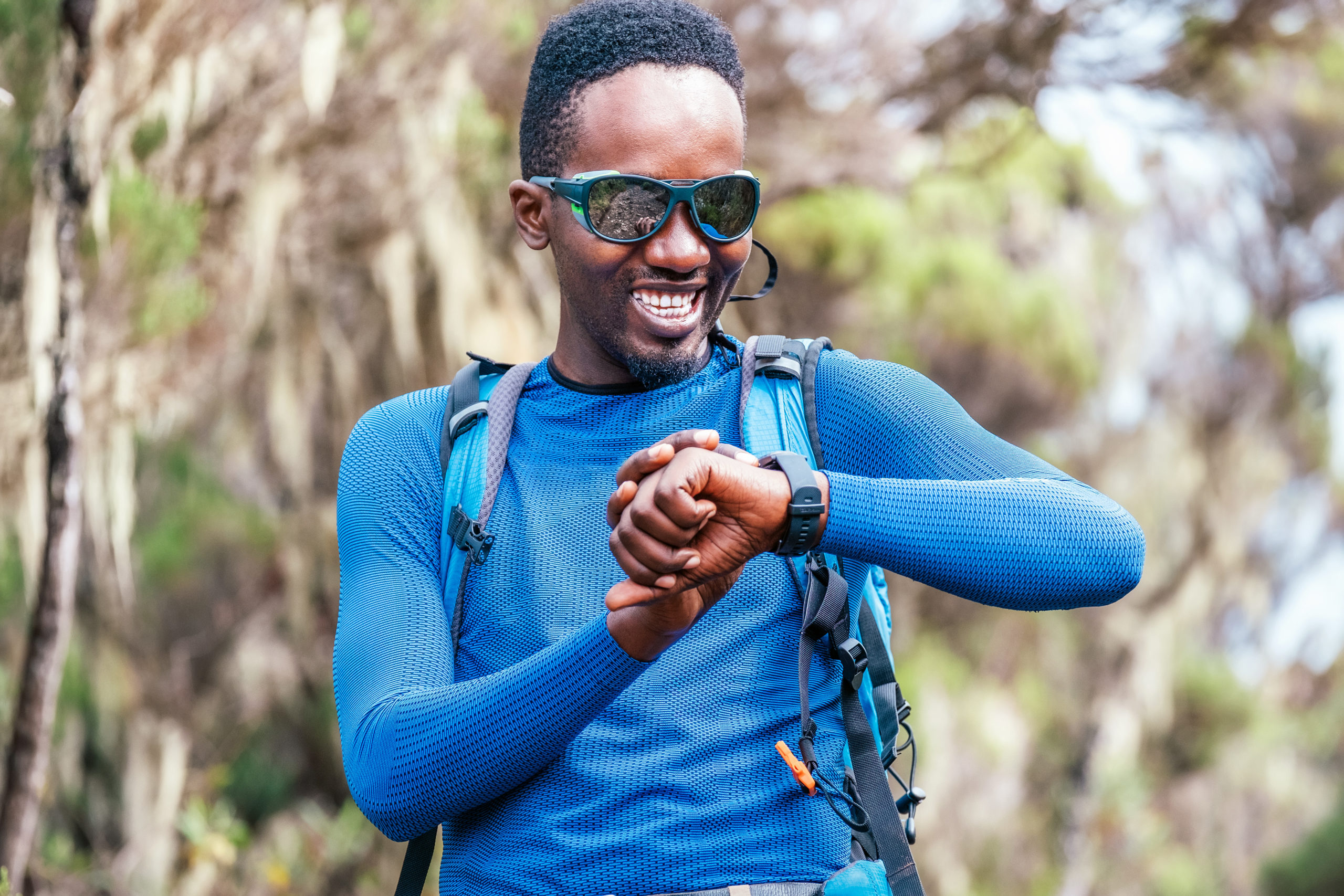 man checking smartwatch on hike