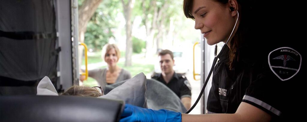 EMT helping patient in ambulance - Verizon discount for first responders