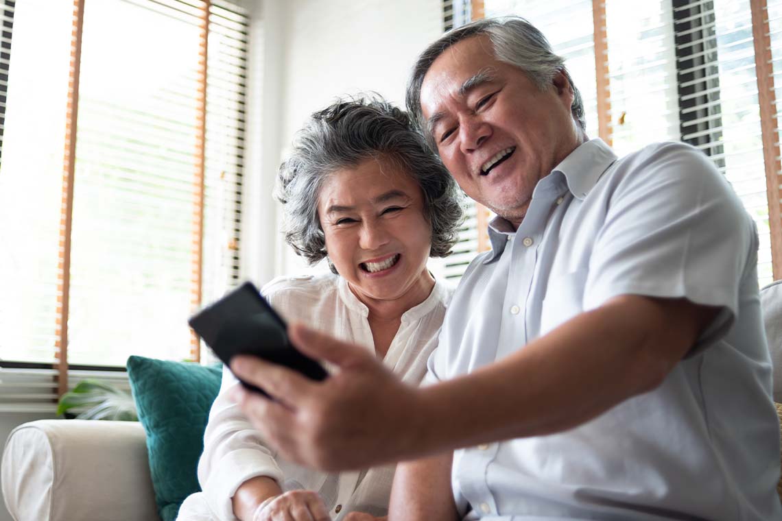 senior couple taking selfie with smartphone