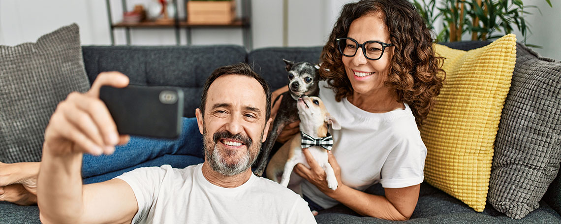 tech-savvy grandparents enjoying their tech gifts on couch