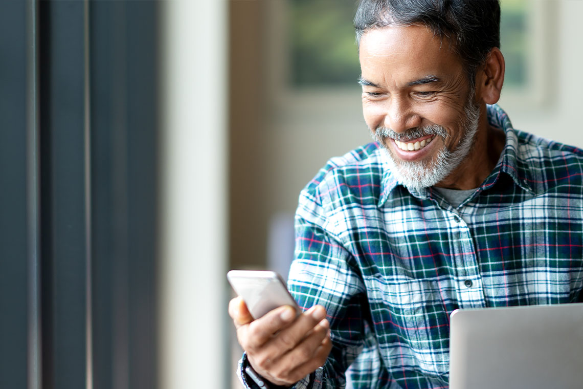 senior man checking smartphone