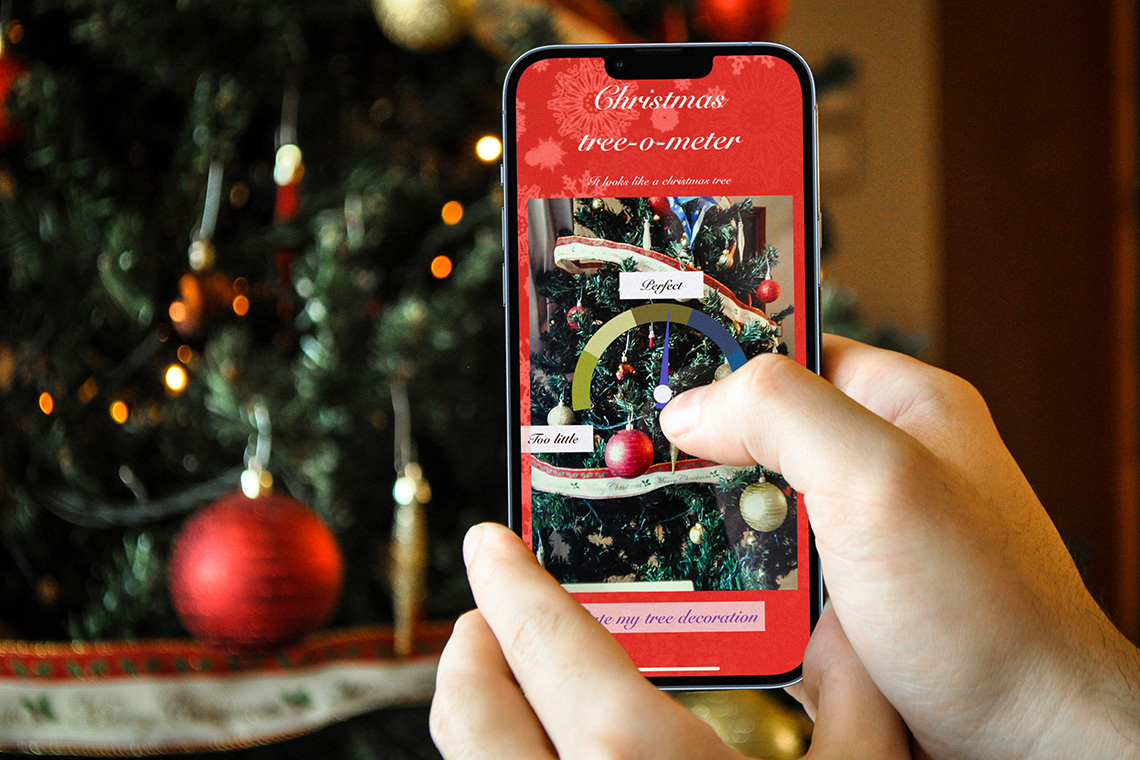 person using christmas tree o meter app on iOS