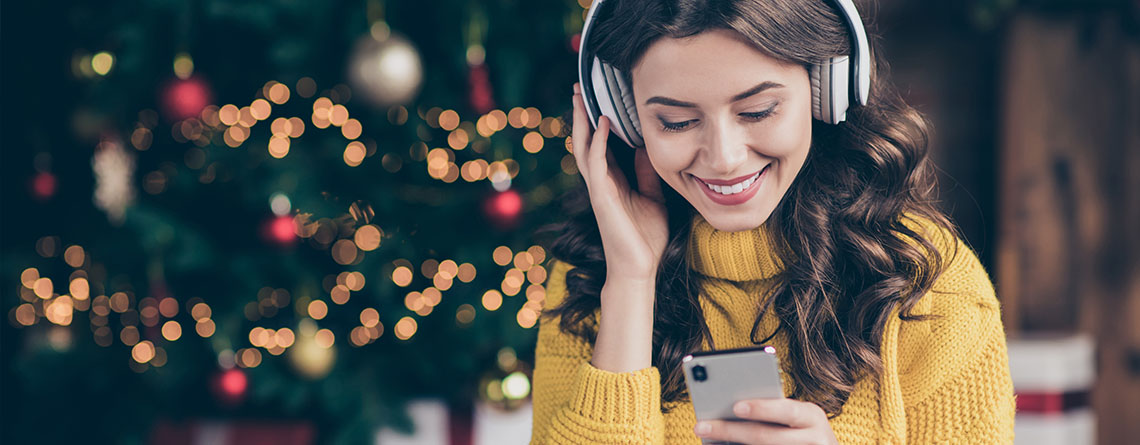 woman with headphones listing to christmas music