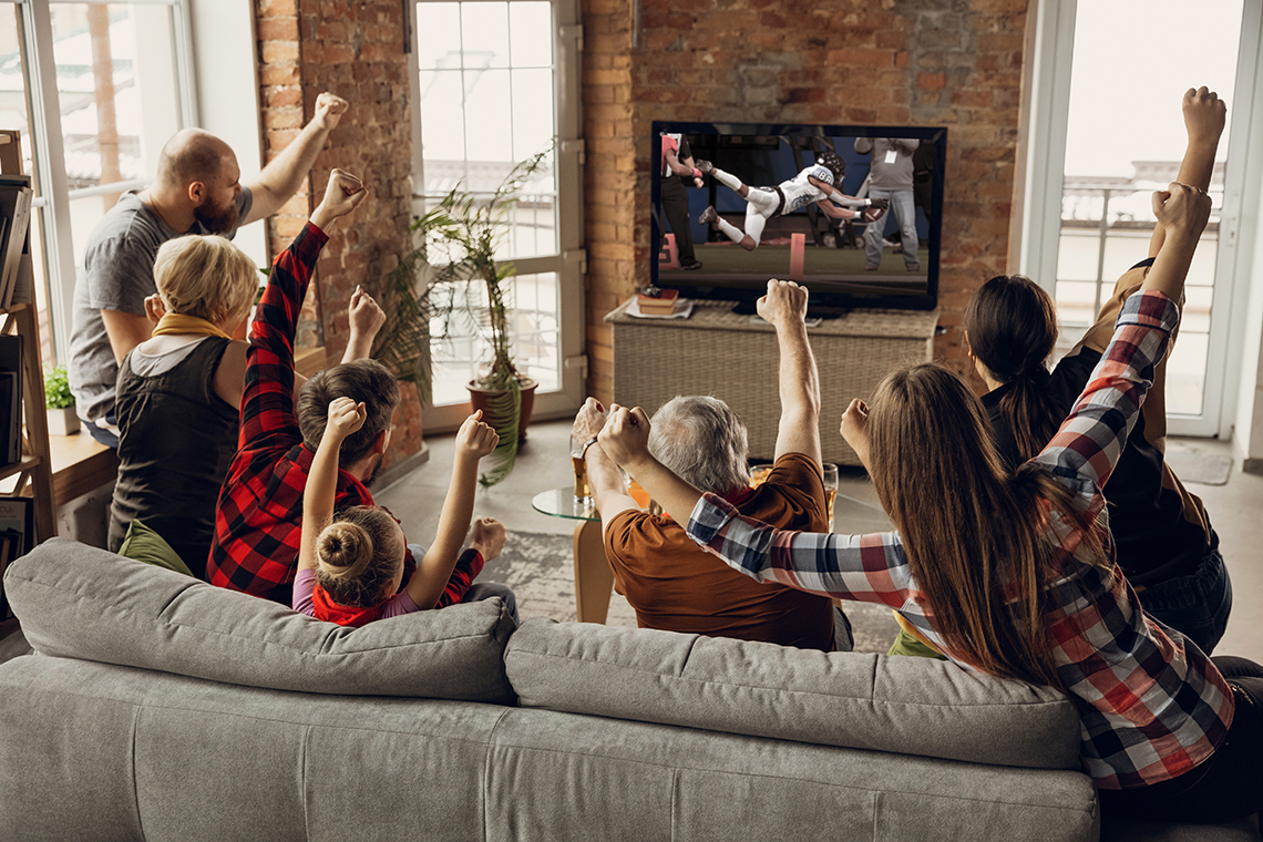 family watching football game on thanksgiving