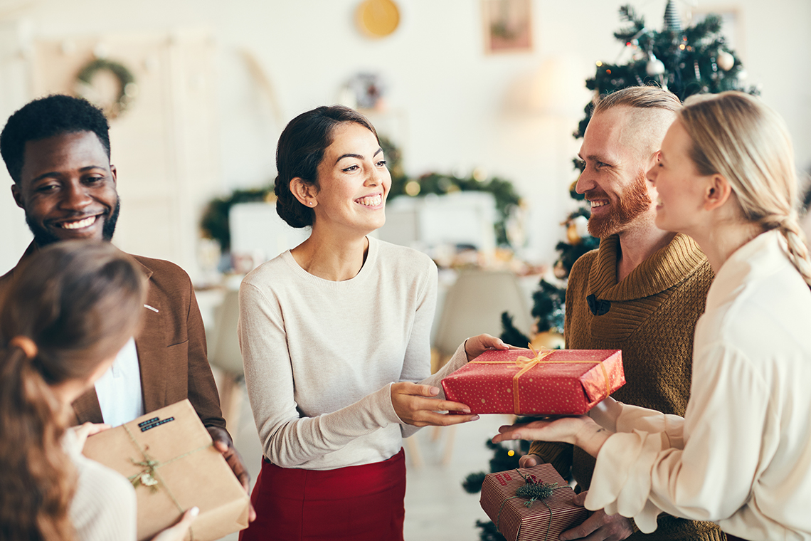 co-workers exchanging gifts at office party