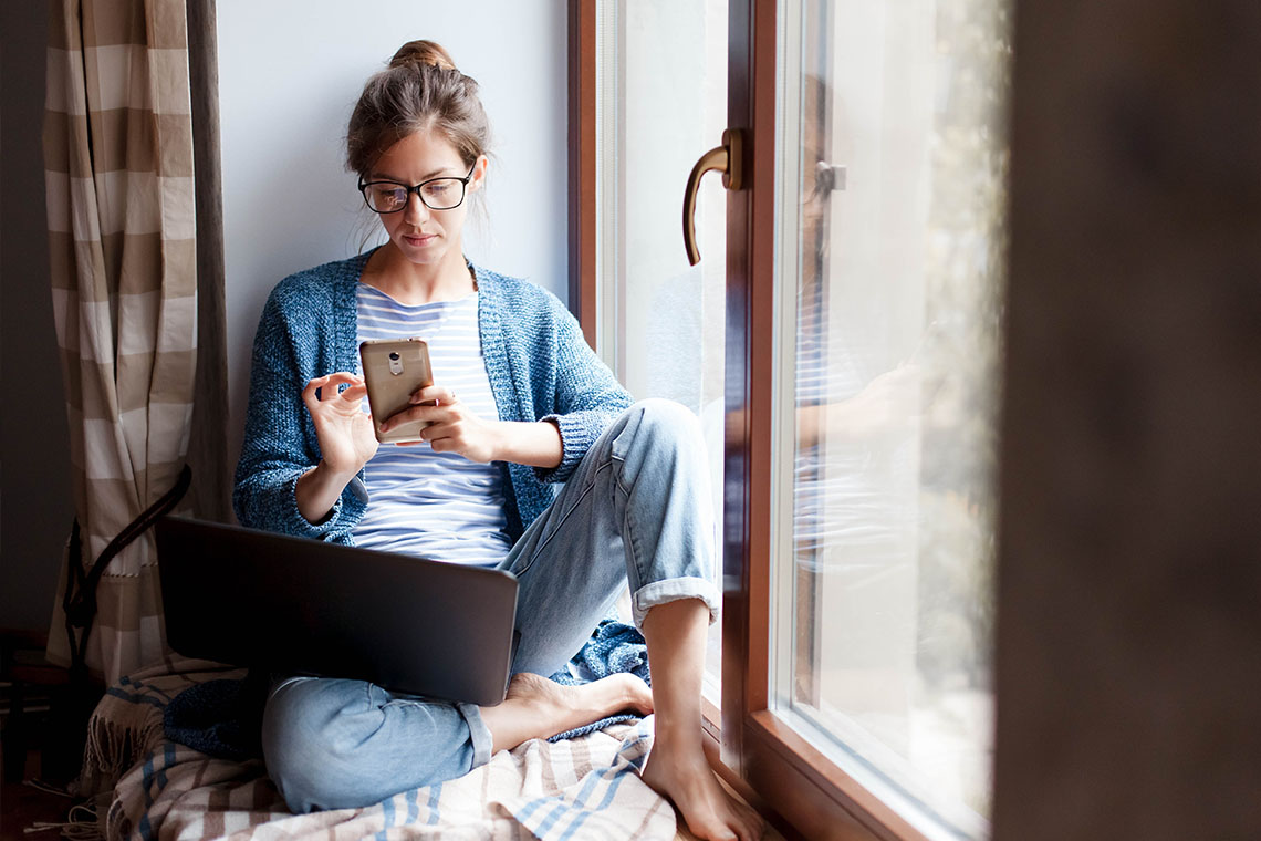 woman looking for new careers with smartphone