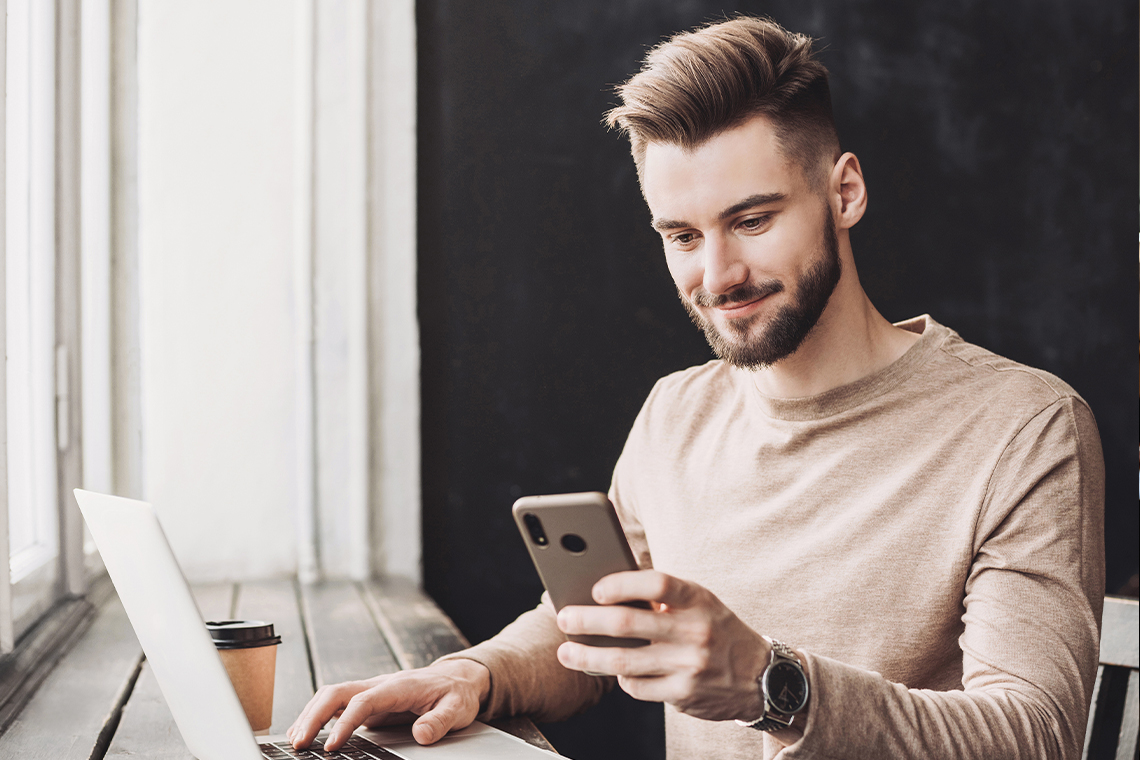 man at coffee shop planning new years resolutions 2022