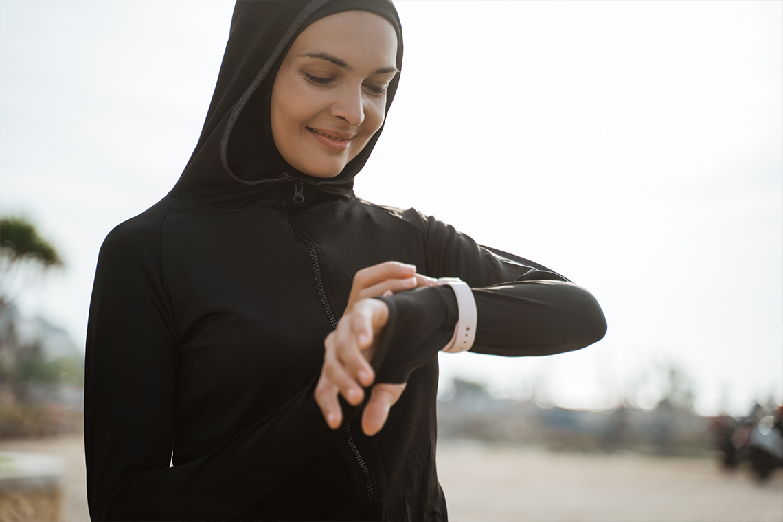 woman checking smartwatch outside