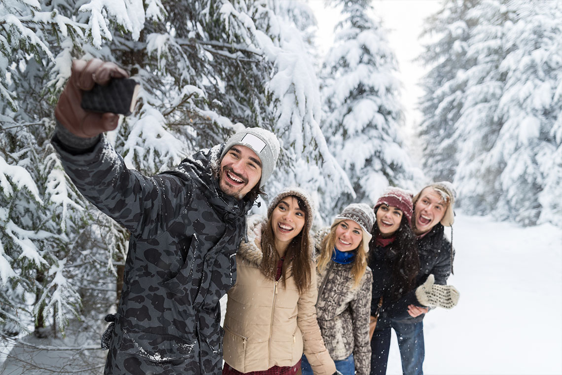 friends taking selfie outside on a snowy day