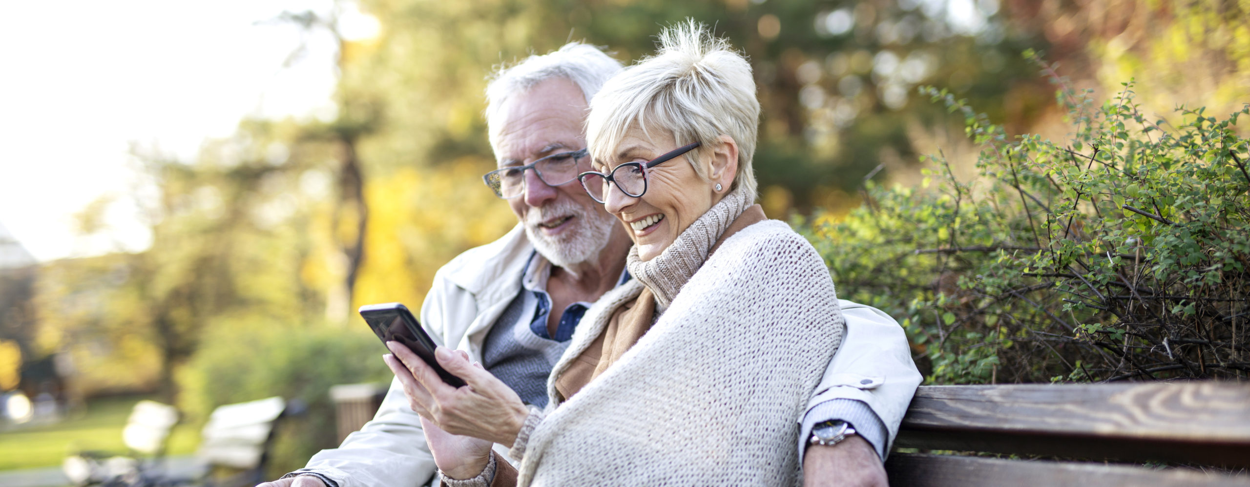 senior couple enjoying new entry level smartphone