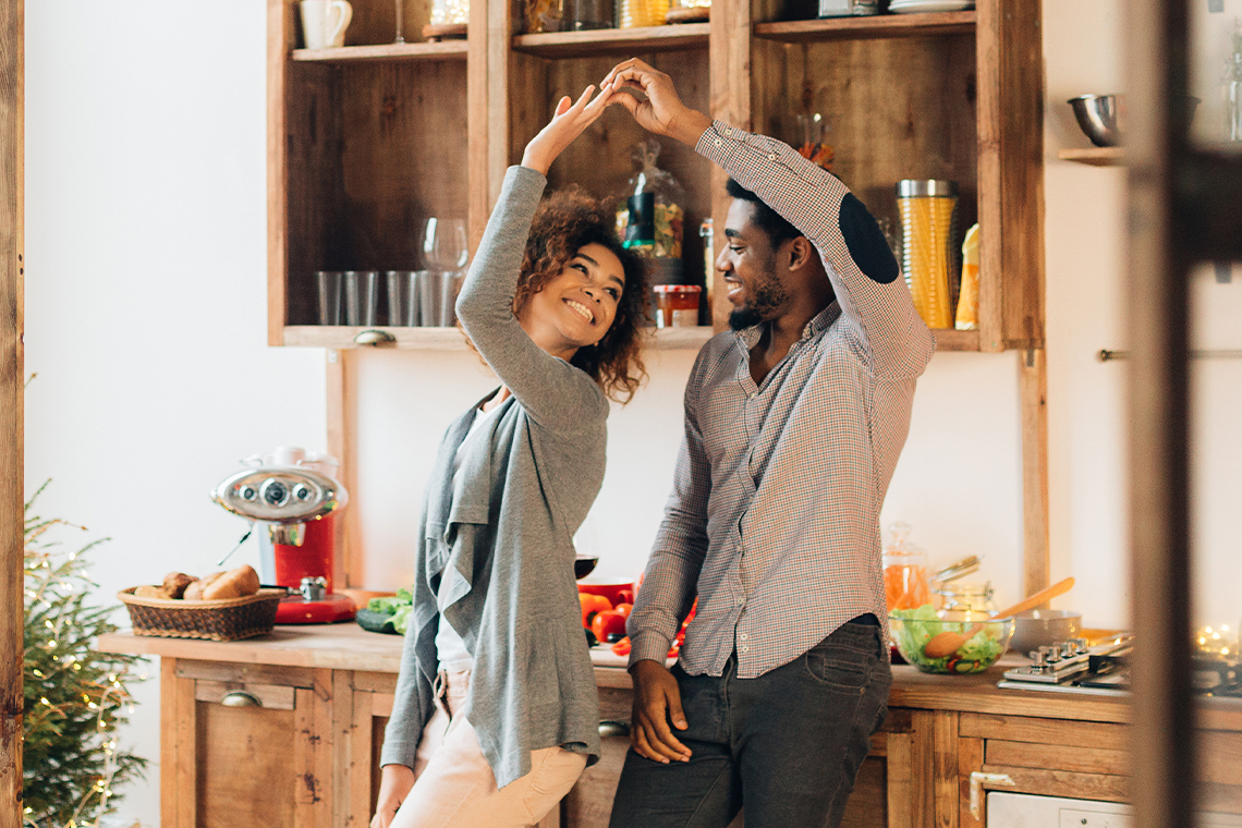 couple dancing in kitchen on valentines day