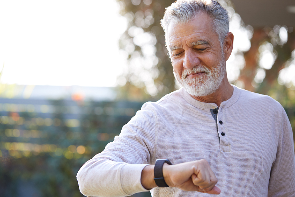 senior man with wearable tech - apple watch