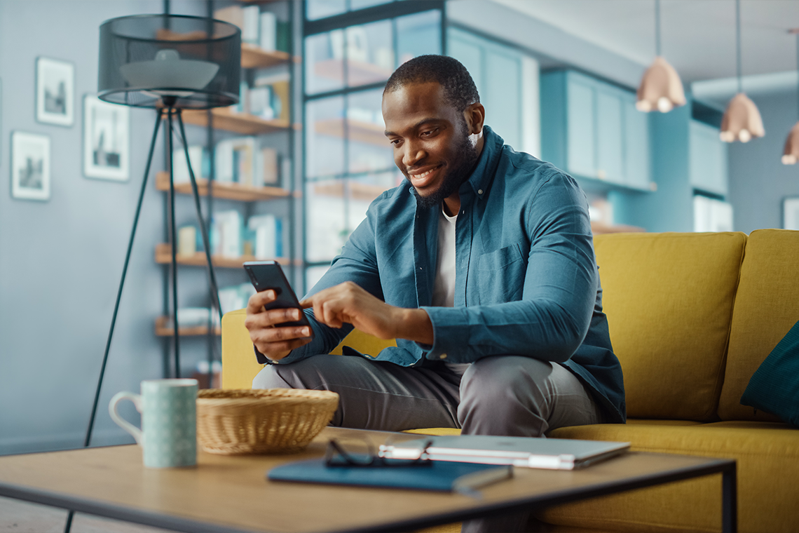 man using 5G home internet to check email on smartphone