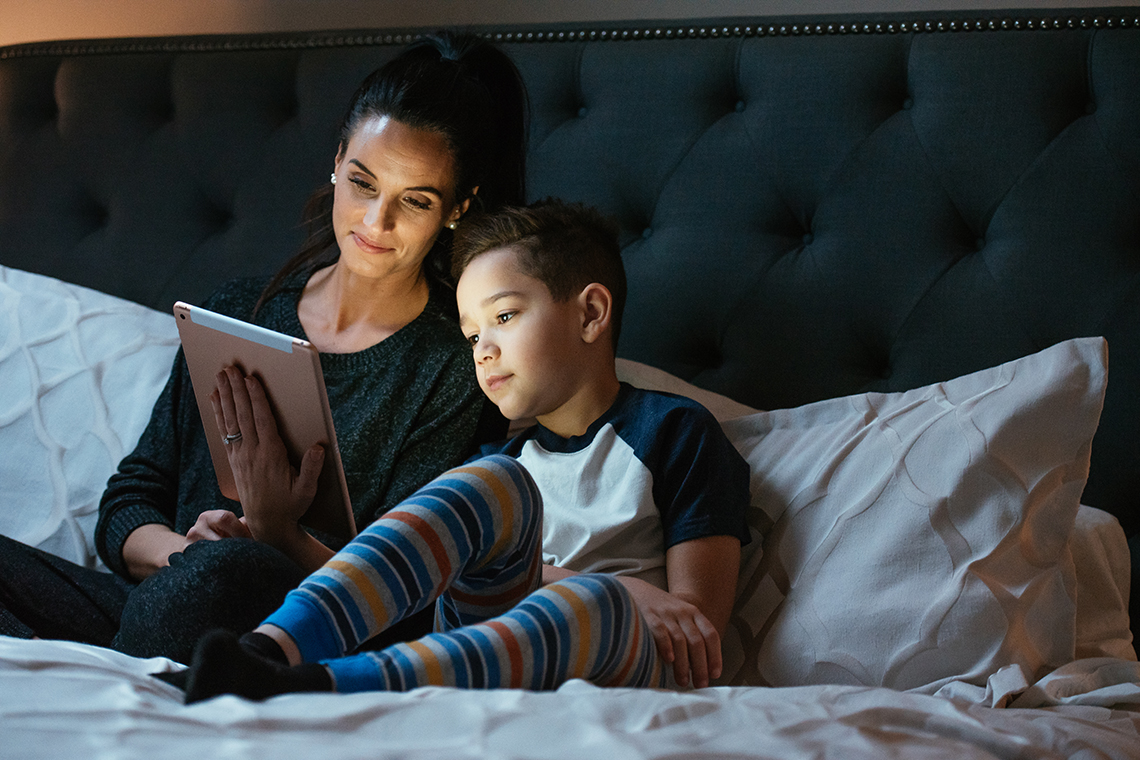 mother and son streaming movie on tablet