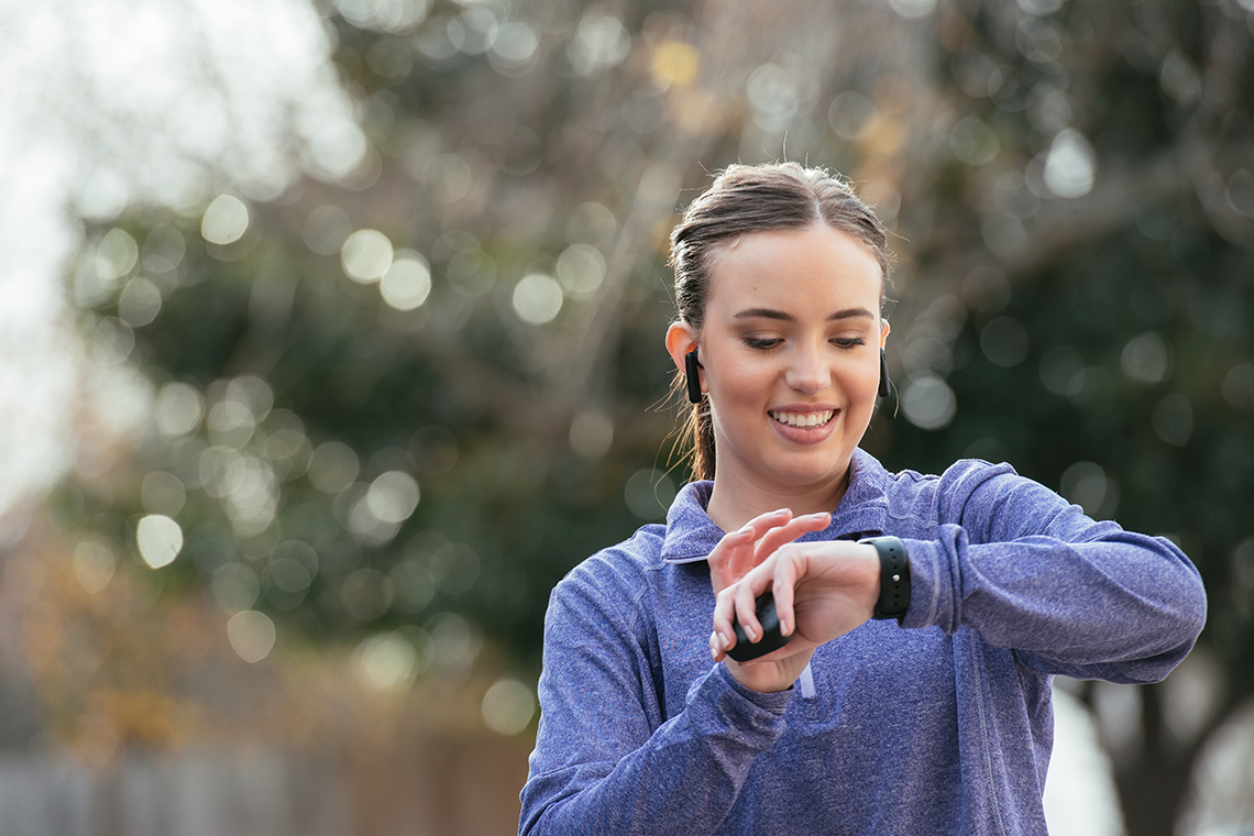 girl checking smartwatch before going on a jog