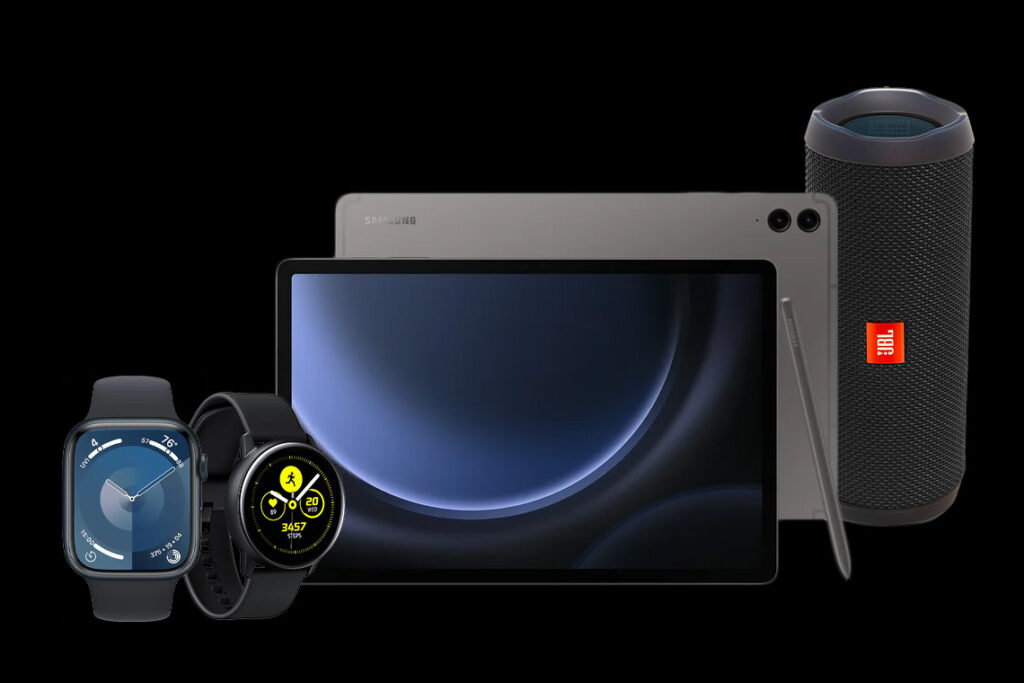 An assortment of tablets, wireless speakers, and smartwatches against a black backdrop.