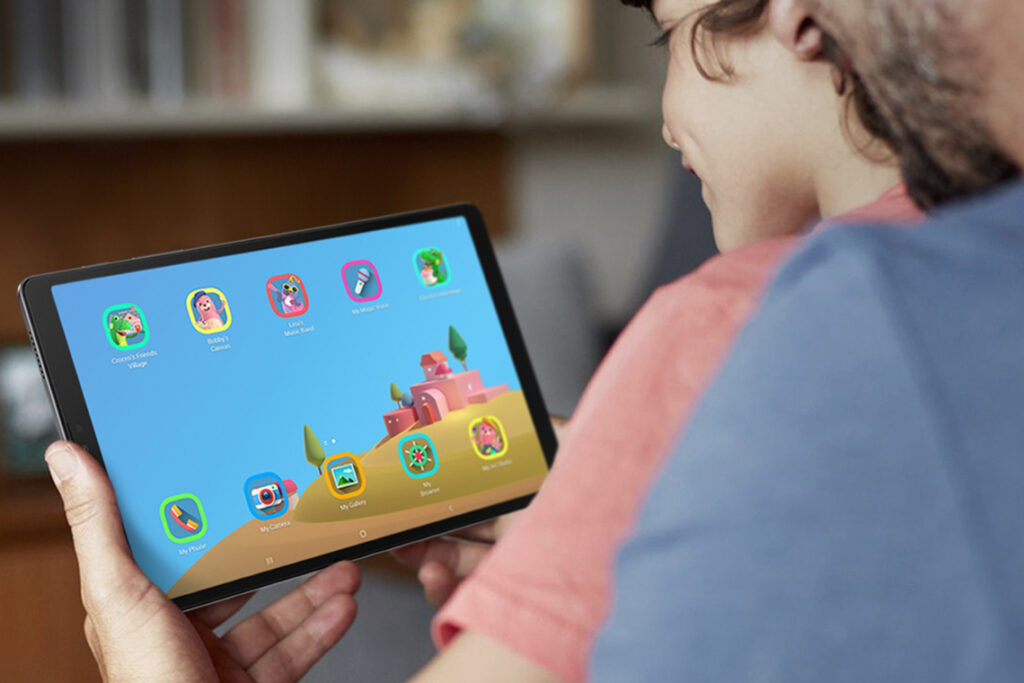 A young student in an orange shirt looks at apps on a tablet at school.