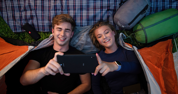 couple laying down watching phone together