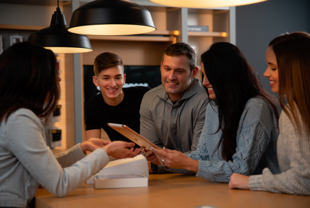 family around table with tablet