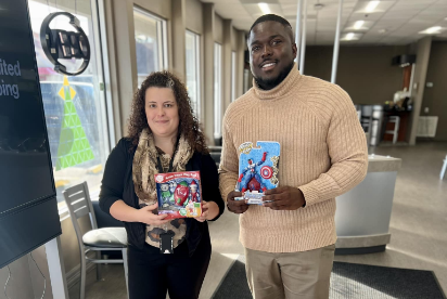 man and woman donating toys to donation box
