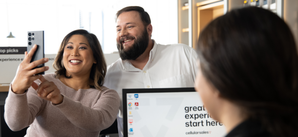 couple taking a selfie in cellular sales store