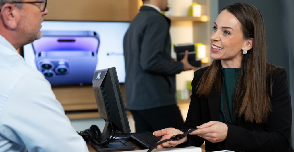 employee showing customer smartwatch