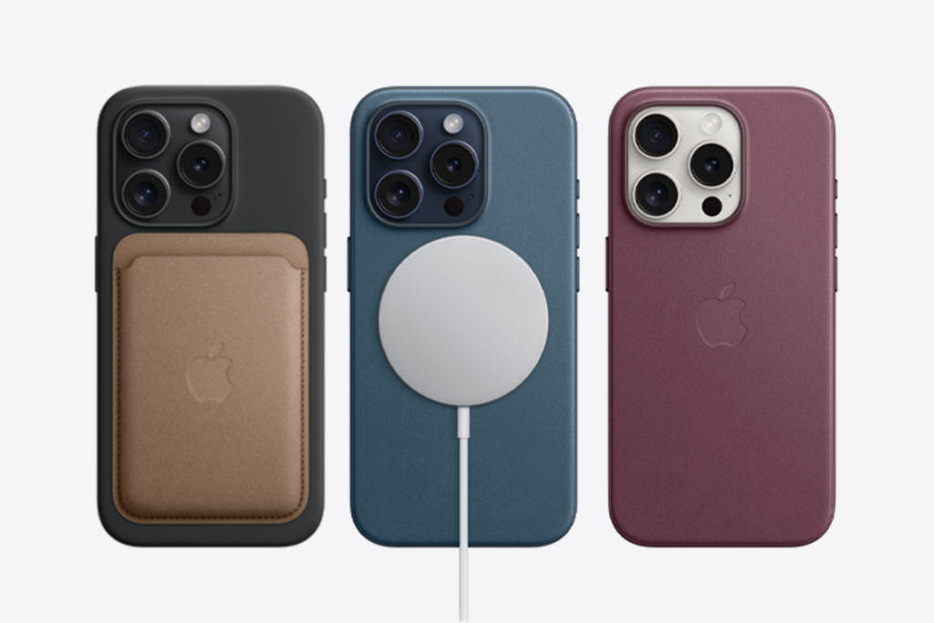 Three iPhones shown side by side with MagSafe accessories attached. Left is a black phone with MagSafe wallet. Middle is a blue phone with a MagSafe charger. Right is a deep red with MagSafe-compatible case.