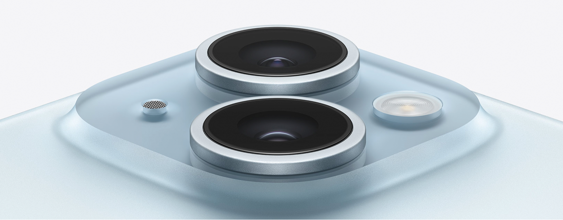 Camera lens array on a pale blue Apple iPhone 15.