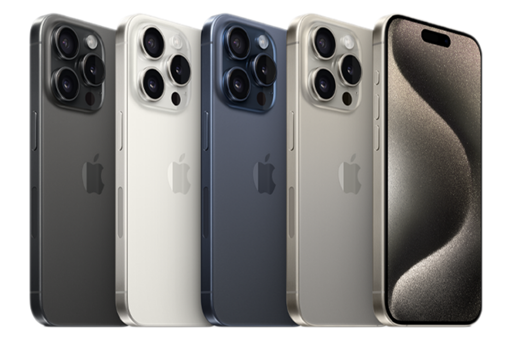 A row of Apple iPhone 15 Pros, from left to right: Black Titanium, White Titanium, Blue Titanium, Natural Titanium